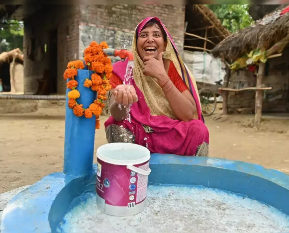 Happy woman with water tap